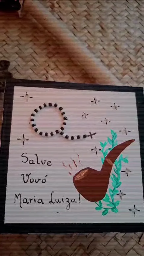 Quadro pintado à mão com terço, cachimbo e folhas, escrito Salve Vovó Maria Luiza